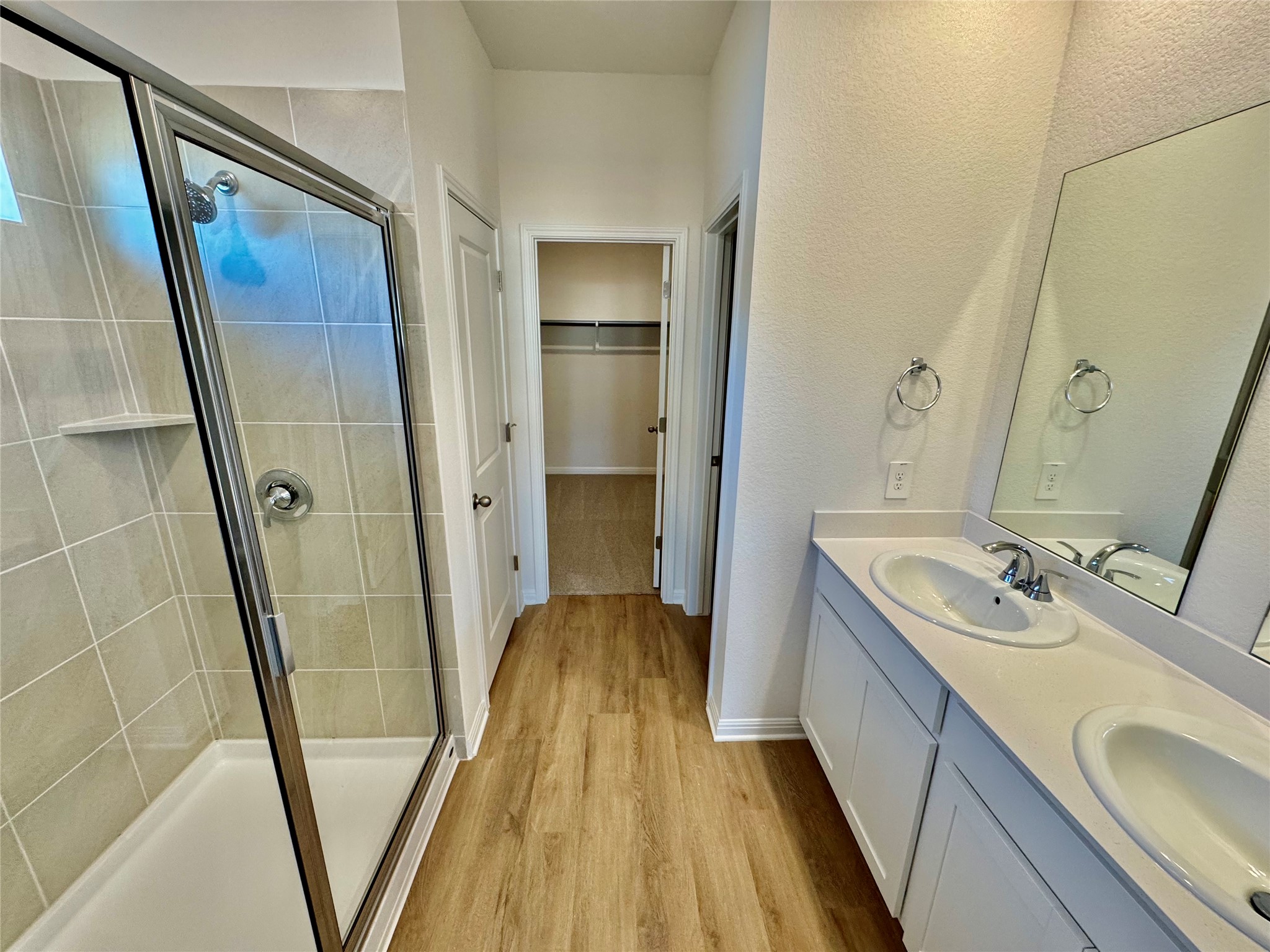 175 Fossil Drive Kyle, TX 78640 - Photo 4 of 7 a bathroom with a sink a mirror and a shower