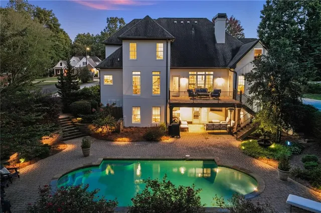 a front view of a house with a yard and green space