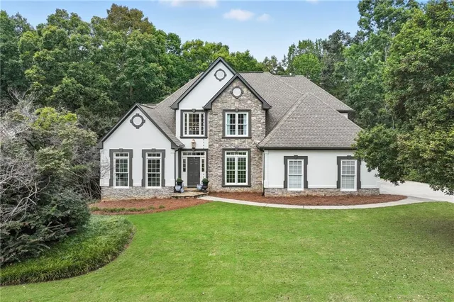 a front view of a house with a yard