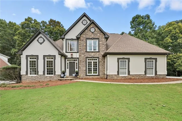 a view of a dining room with furniture a rug and a large window