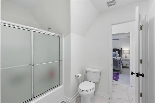 a view of a swimming pool with potted plants and large trees