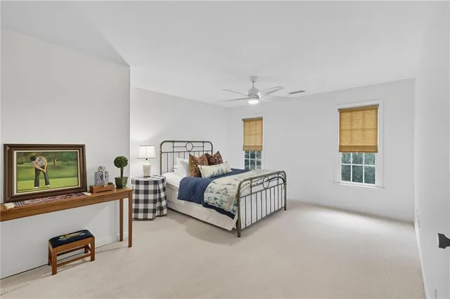 an aerial view of a house with outdoor space and trees all around