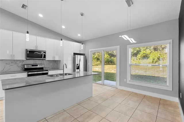 a kitchen with stainless steel appliances a sink stove and microwave
