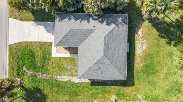 an aerial view of a house with swimming pool