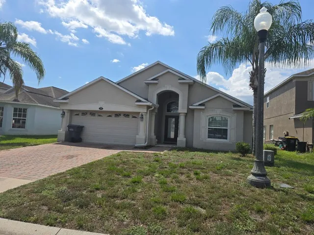 a front view of a house with yard and garage