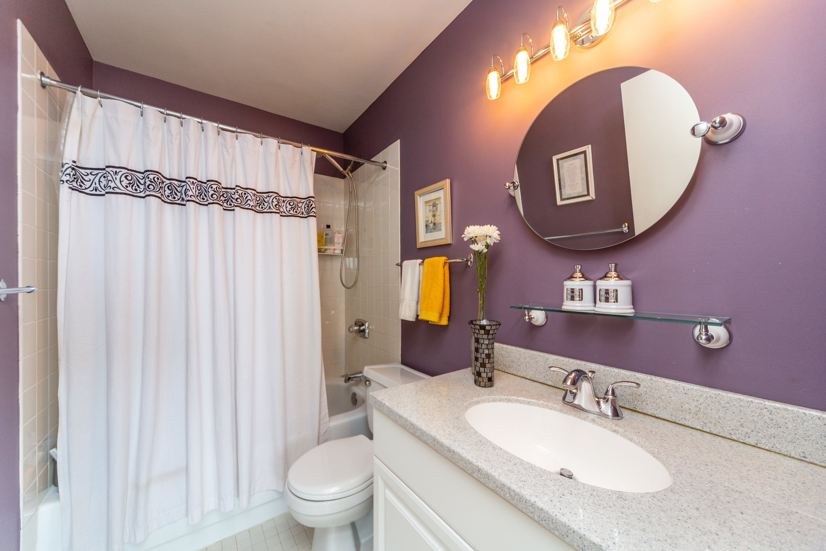 5320 North Sheridan Road, Unit 2401 Chicago, IL 60640 - Photo 13 of 21 a bathroom with a granite countertop sink vanity mirror and toilet