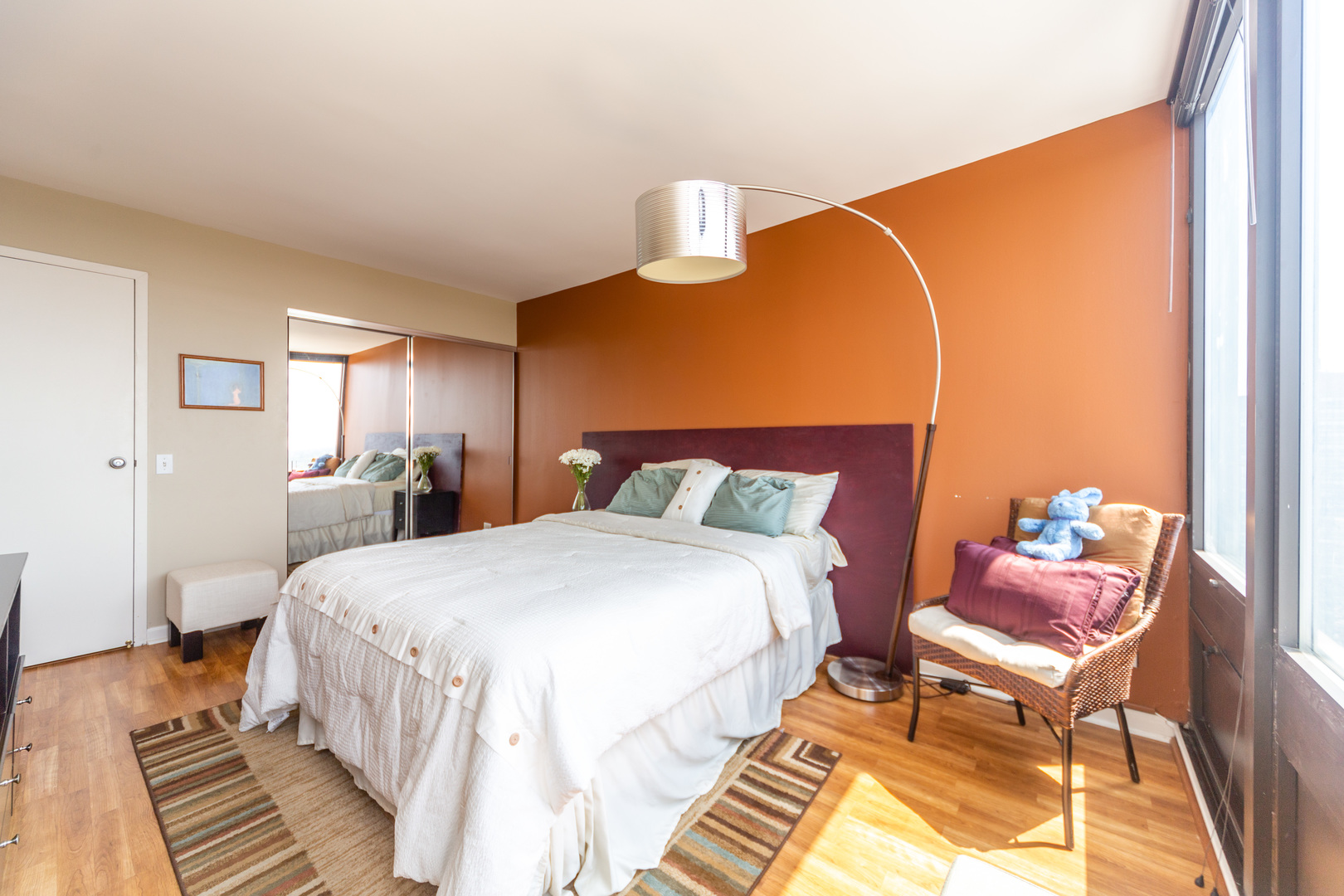 5320 North Sheridan Road, Unit 2401 Chicago, IL 60640 - Photo 15 of 21 a bedroom with a bed and wooden floor