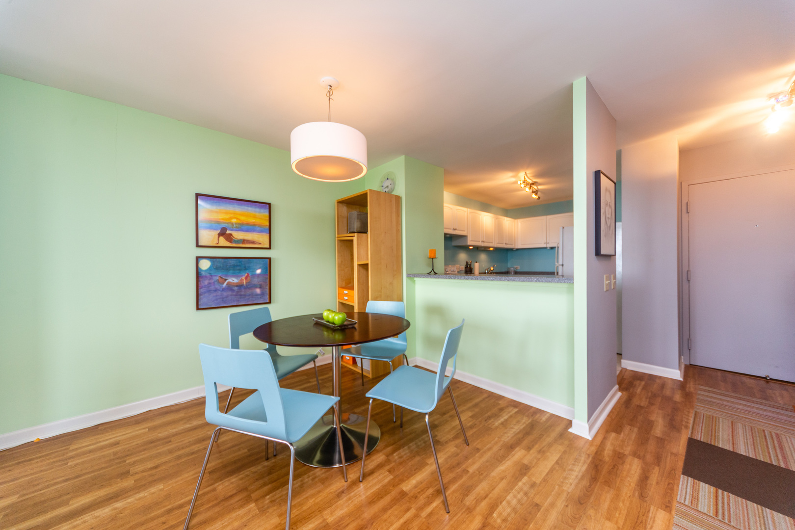 5320 North Sheridan Road, Unit 2401 Chicago, IL 60640 - Photo 9 of 21 a view of a dining room with furniture and wooden floor