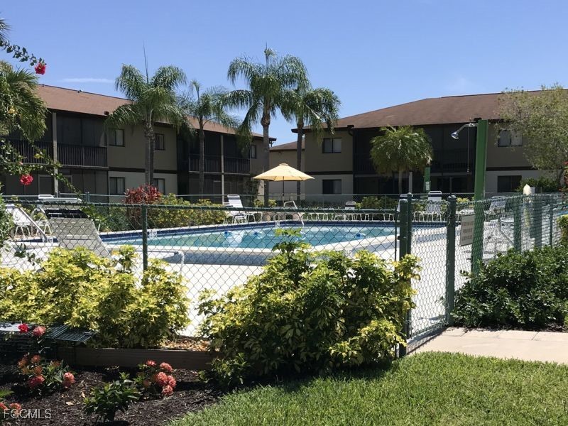 4790 South Cleveland Avenue, Unit 908 Fort Myers, FL 33907 - Photo 1 of 10 a view of a swimming pool with a patio
