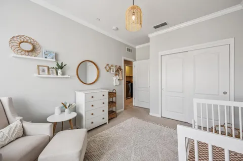 a bedroom with a bed and a chandelier