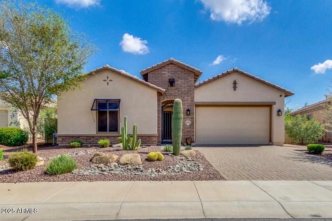 4647 North Aldea Road East Litchfield Park, AZ 85340 - Photo 1 of 49 a front view of a house with a yard and garage