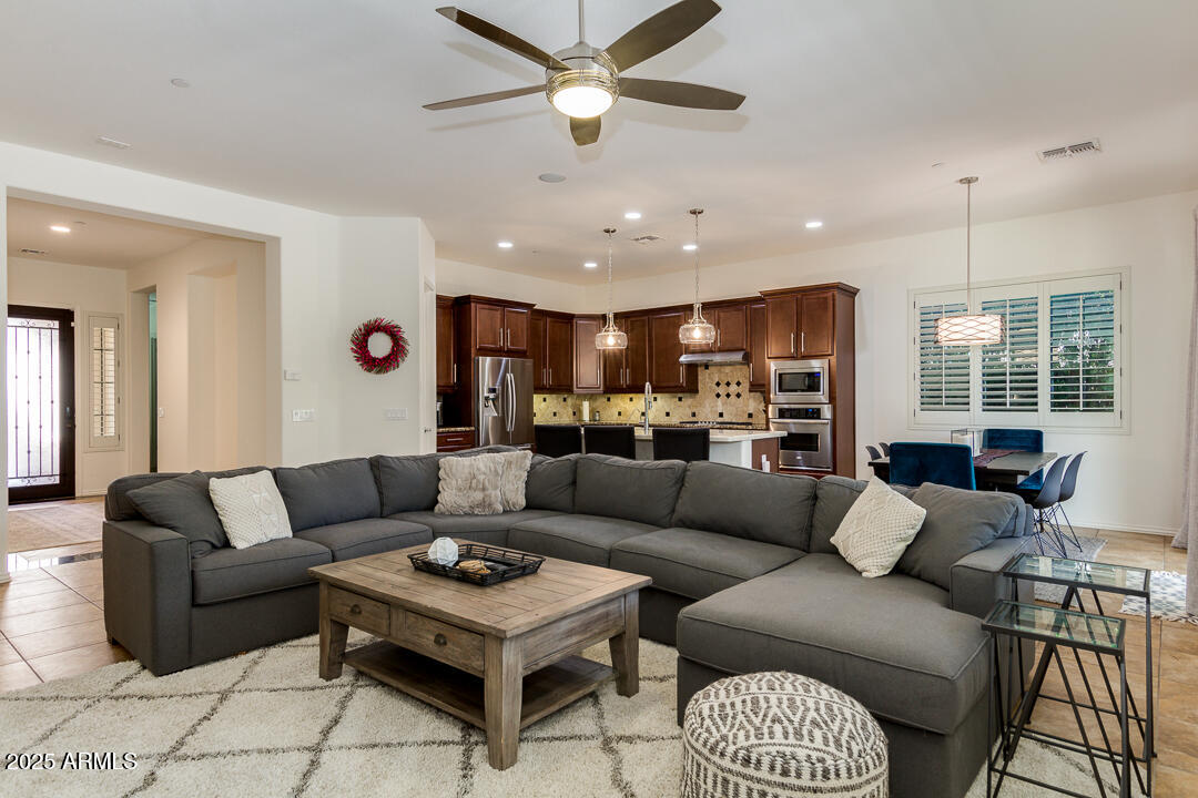 4647 North Aldea Road East Litchfield Park, AZ 85340 - Photo 14 of 49 a living room with furniture kitchen view and a large window