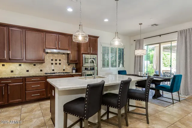 a kitchen with stainless steel appliances granite countertop a stove and a sink