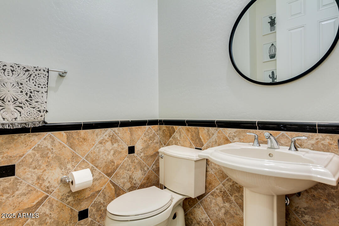 4647 North Aldea Road East Litchfield Park, AZ 85340 - Photo 21 of 49 a bathroom with a sink and a mirror