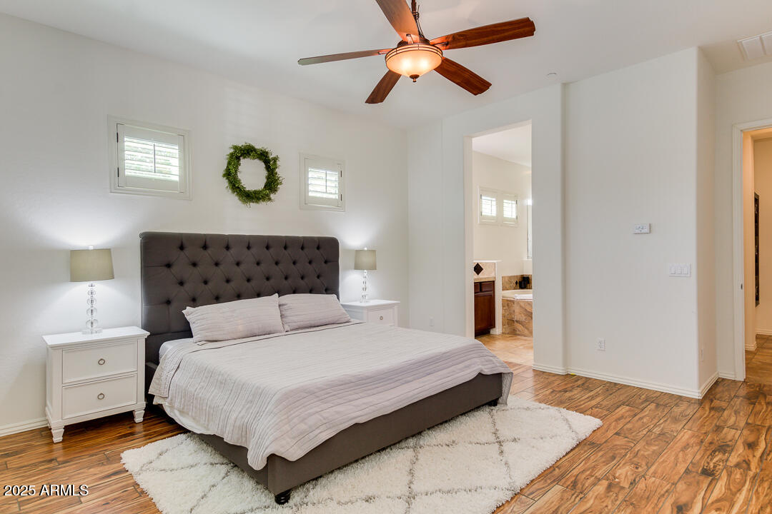 4647 North Aldea Road East Litchfield Park, AZ 85340 - Photo 23 of 49 a bedroom with a large bed and a chandelier