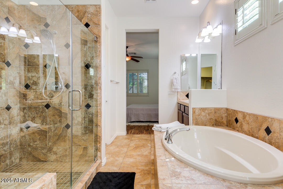 4647 North Aldea Road East Litchfield Park, AZ 85340 - Photo 27 of 49 a bathroom with a bathtub and shower