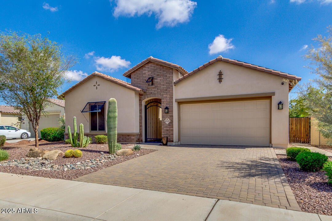 4647 North Aldea Road East Litchfield Park, AZ 85340 - Photo 3 of 49 a front view of a house with a yard and garage