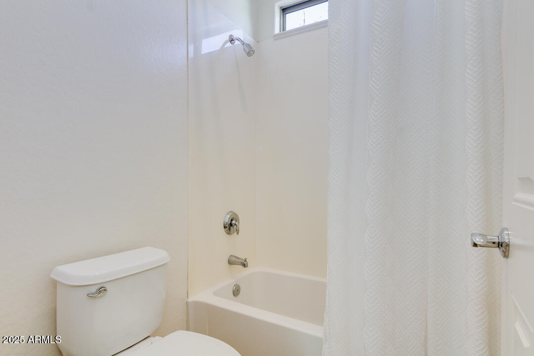 4647 North Aldea Road East Litchfield Park, AZ 85340 - Photo 32 of 49 a white bath tub sitting next to a white toilet