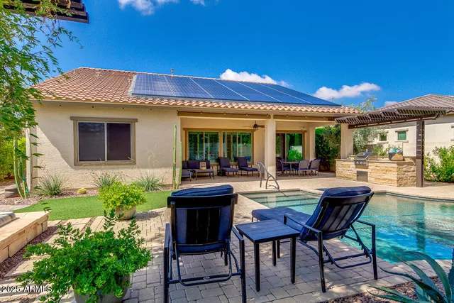 a view of a house with backyard porch and sitting area