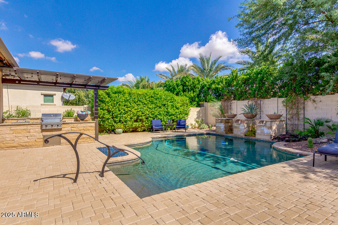 4647 North Aldea Road East Litchfield Park, AZ 85340 - Photo 37 of 49 a view of a swimming pool with a patio