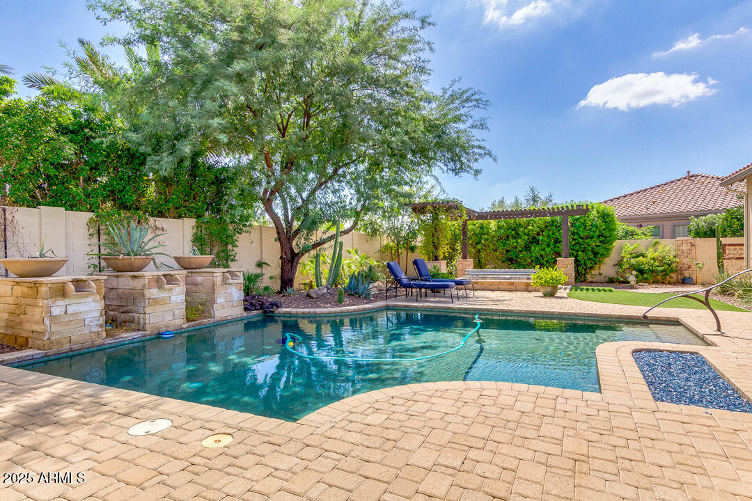 4647 North Aldea Road East Litchfield Park, AZ 85340 - Photo 40 of 49 a view of a swimming pool with a patio