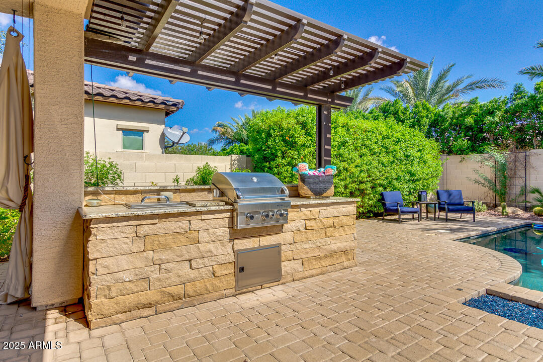 4647 North Aldea Road East Litchfield Park, AZ 85340 - Photo 47 of 49 a view of a patio with table and chairs and potted plants