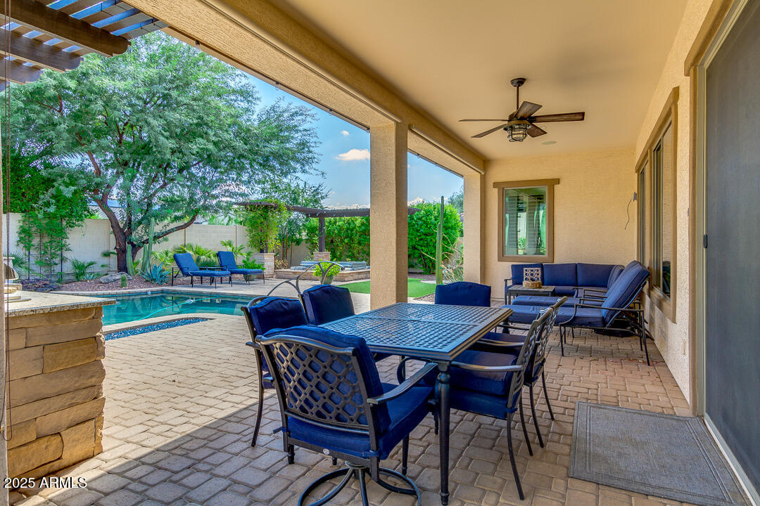 4647 North Aldea Road East Litchfield Park, AZ 85340 - Photo 49 of 49 a view of a patio with dining table and chairs