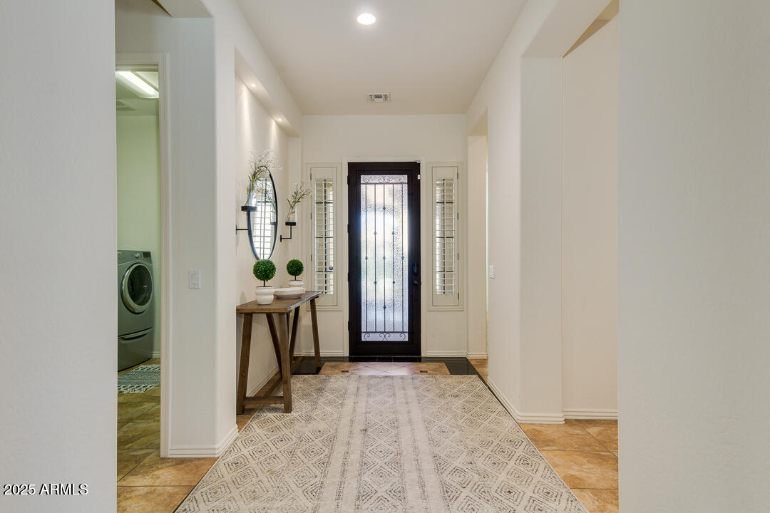 4647 North Aldea Road East Litchfield Park, AZ 85340 - Photo 7 of 49 a view of a hallway to a livingroom with a furniture