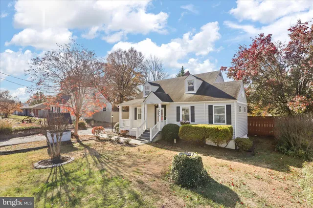 a front view of a house with a yard covered with snow