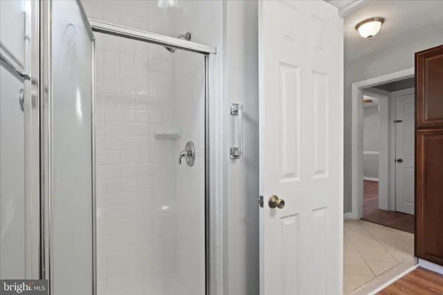 a bathroom with a glass shower door