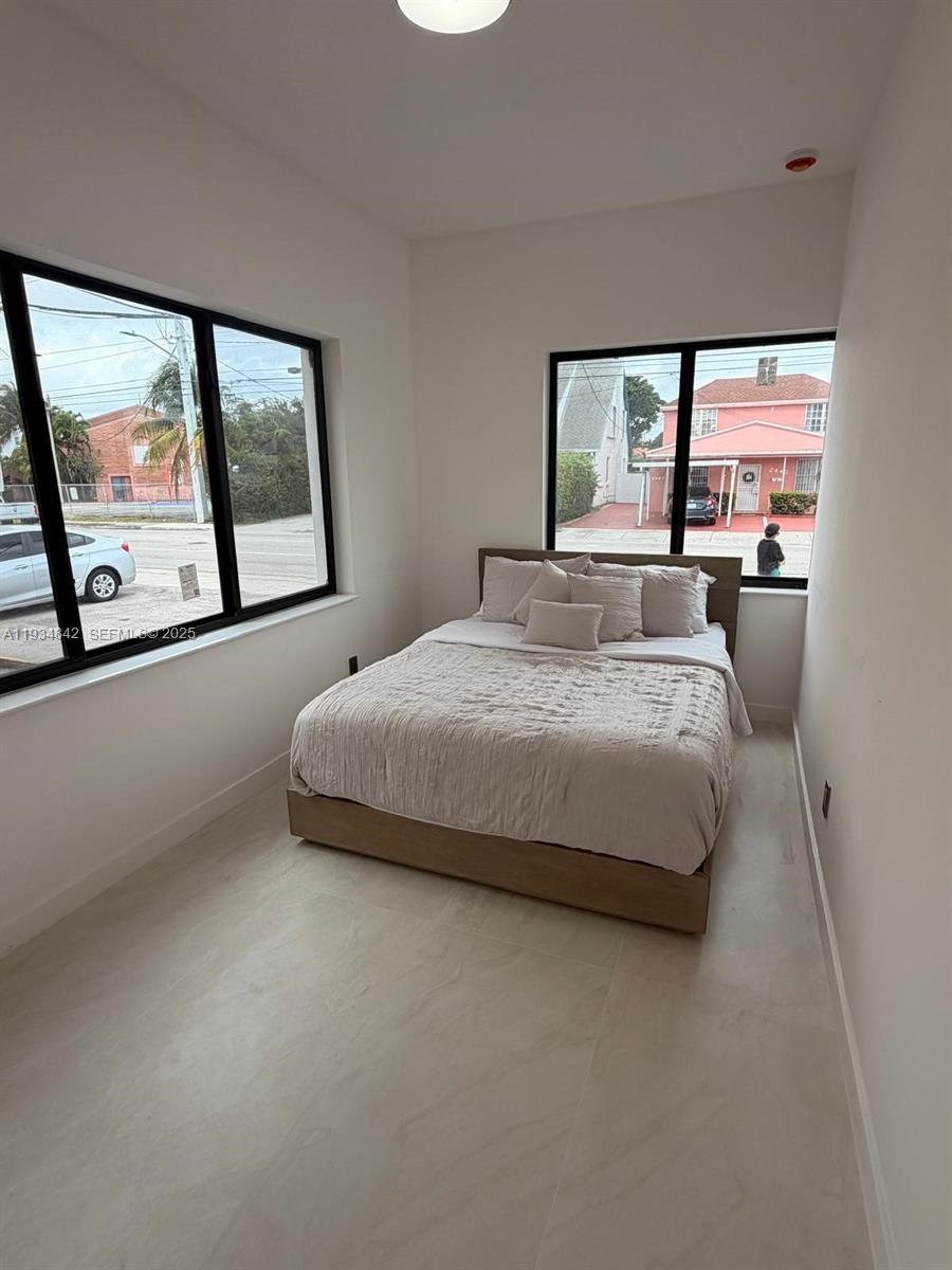 2436 Southwest 7th Street, Unit 3 Miami, FL 33135 - Photo 7 of 17 a bedroom with a bed and large window