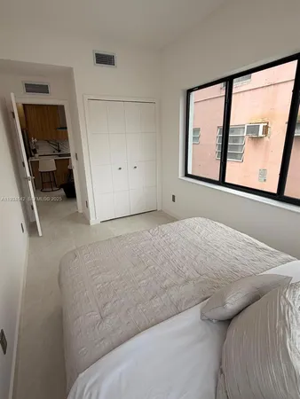 a bedroom with a bed and window