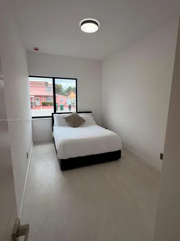 a large white bed in a white room