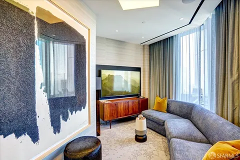 a living room filled with furniture and a floor to ceiling window
