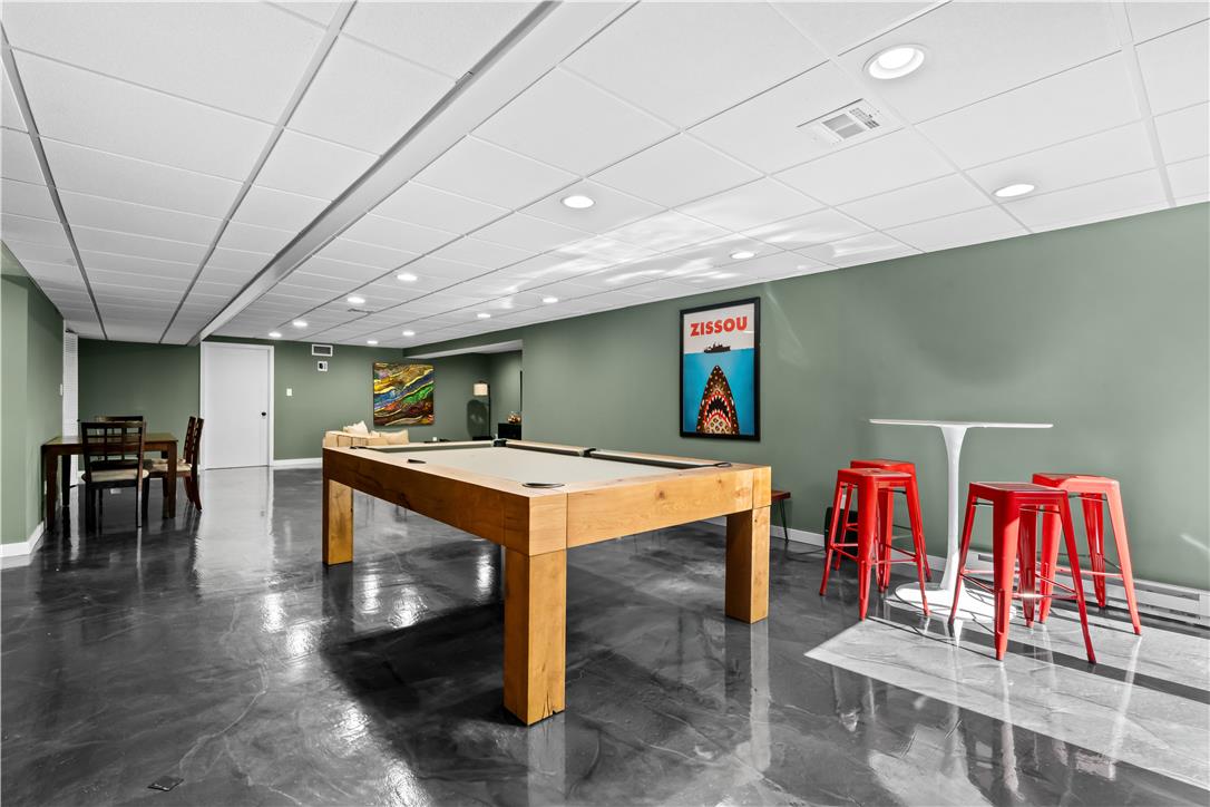 1506 Pleasant View Road Coopersburg, PA 18036 - Photo 73 of 97 A spacious recreation room featuring a sleek pool table and polished concrete flooring.