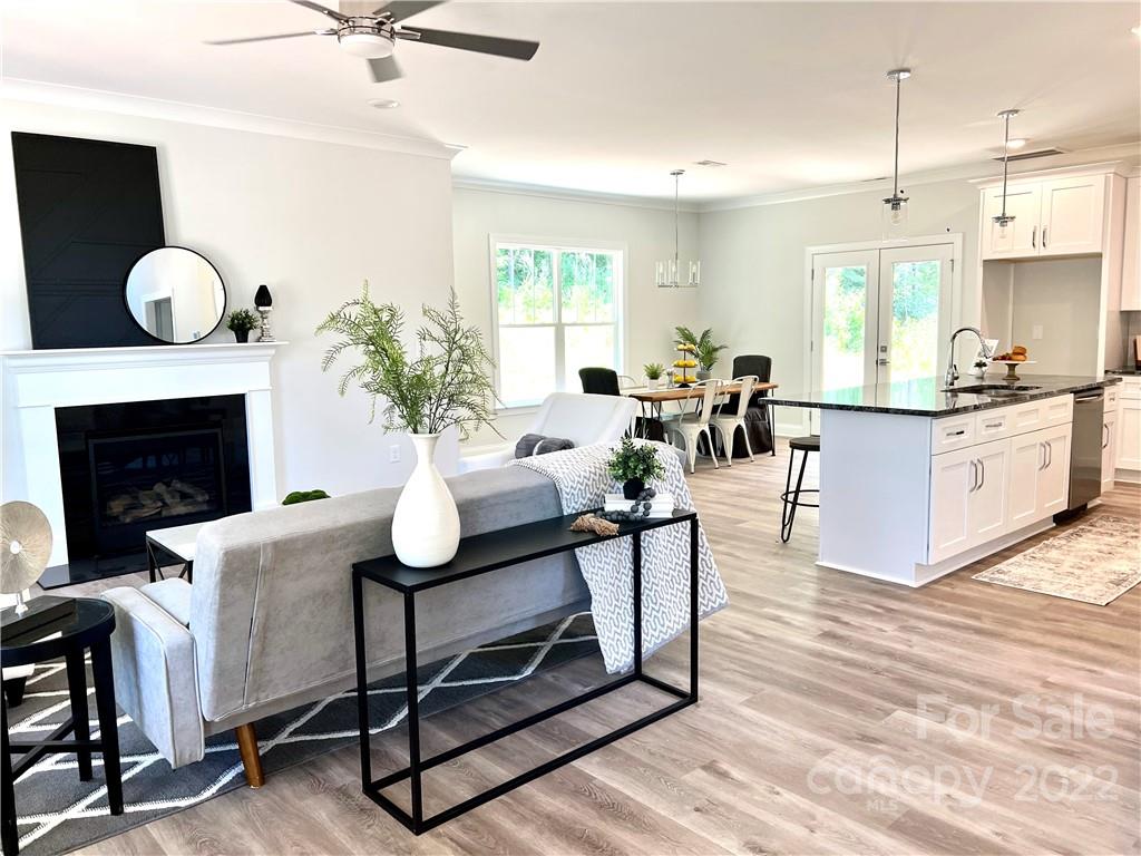 1339 Reservation Road Rock Hill, SC 29730 - Photo 6 of 44 a living room with furniture a chandelier and a fireplace