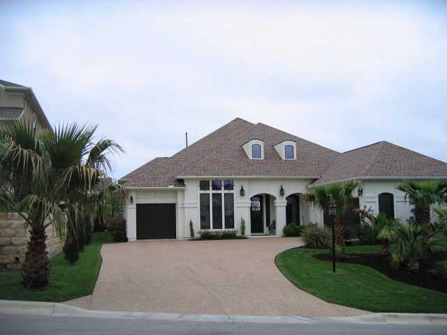 309 Aria Drive Austin, TX 78738 - Photo 1 of 1 a front view of a house with a garden