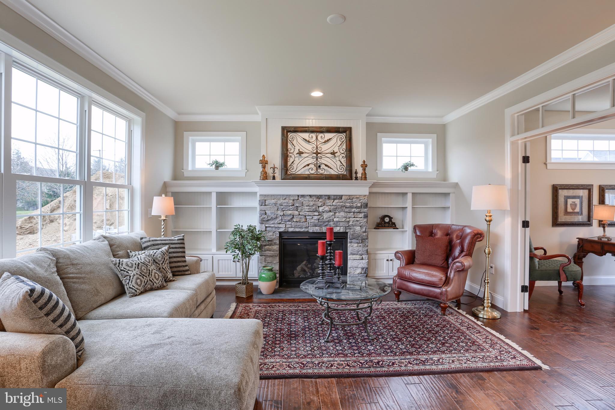 1033 Suffolk Drive Lititz, PA 17543 - Photo 11 of 45 Cozy stone gas fireplace, custom built bookshelve.