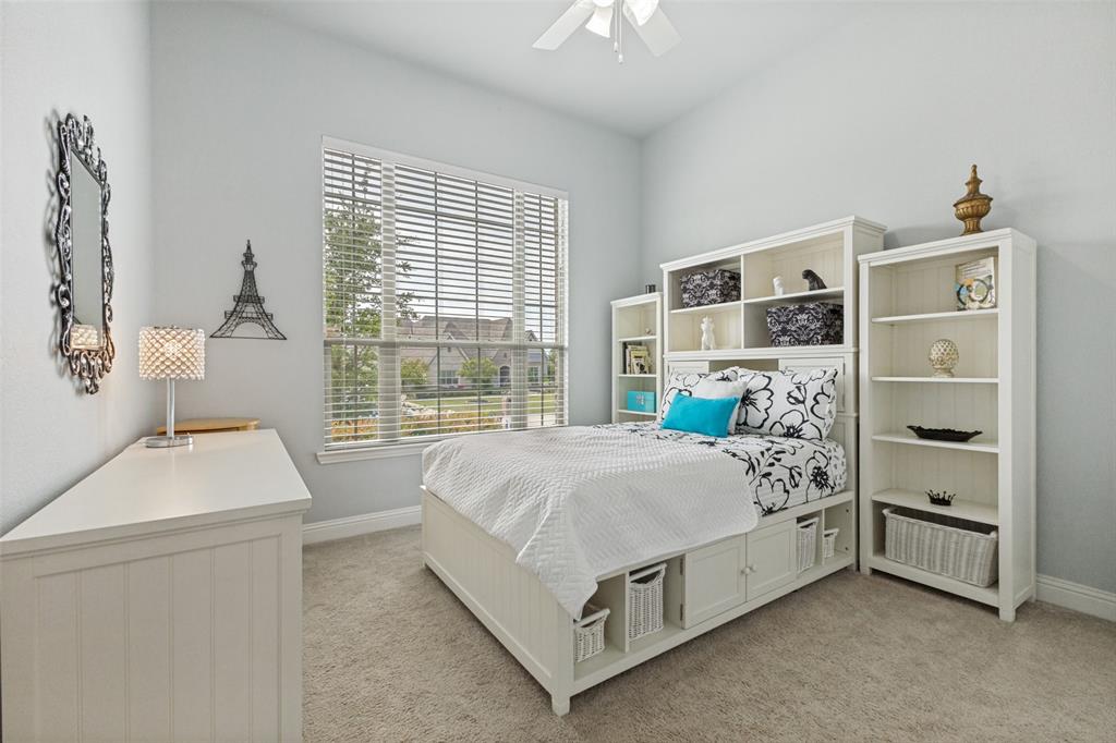 506 Life Spring Drive Rockwall, TX 75087 - Photo 24 of 36 a bed sitting in a bedroom next to a window