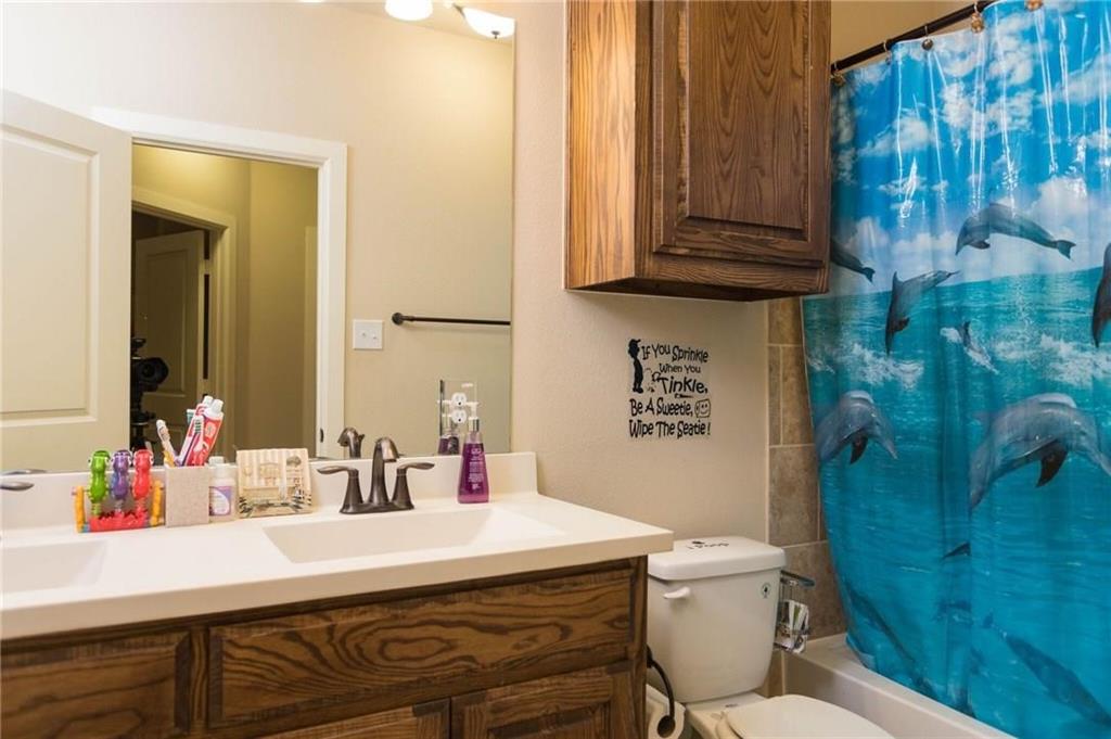 423 Palacio Street Irving, TX 75039 - Photo 12 of 18 Full bathroom featuring shower / bath combo with shower curtain and vanity