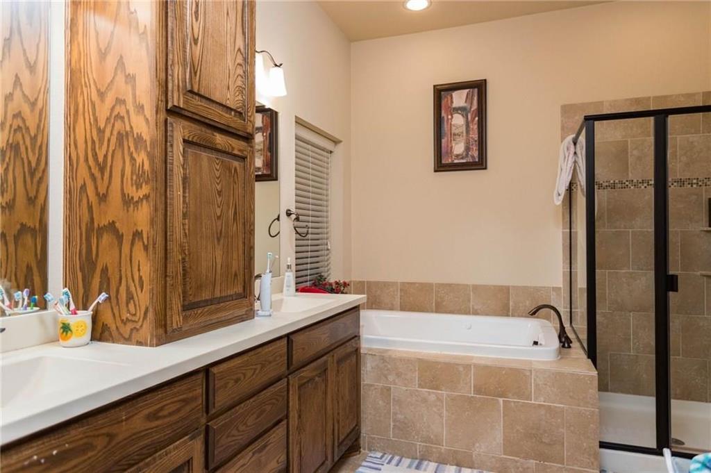 423 Palacio Street Irving, TX 75039 - Photo 13 of 18 Bathroom with a stall shower, double vanity, a garden tub, and recessed lighting