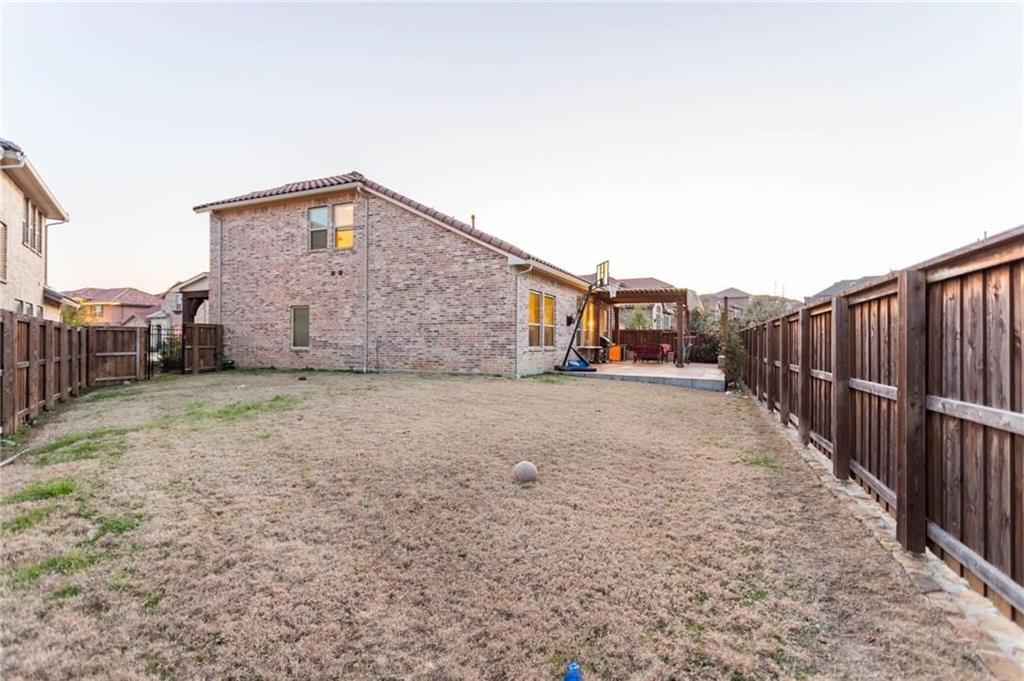 423 Palacio Street Irving, TX 75039 - Photo 2 of 18 Back of property featuring a patio area, a fenced backyard, a pergola, and brick siding