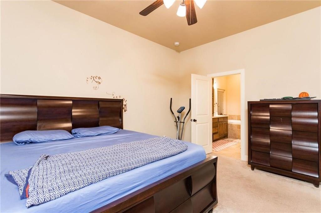 423 Palacio Street Irving, TX 75039 - Photo 5 of 18 Carpeted bedroom with connected bathroom and ceiling fan