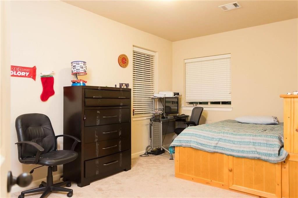 423 Palacio Street Irving, TX 75039 - Photo 8 of 18 Bedroom with light colored carpet and an office area
