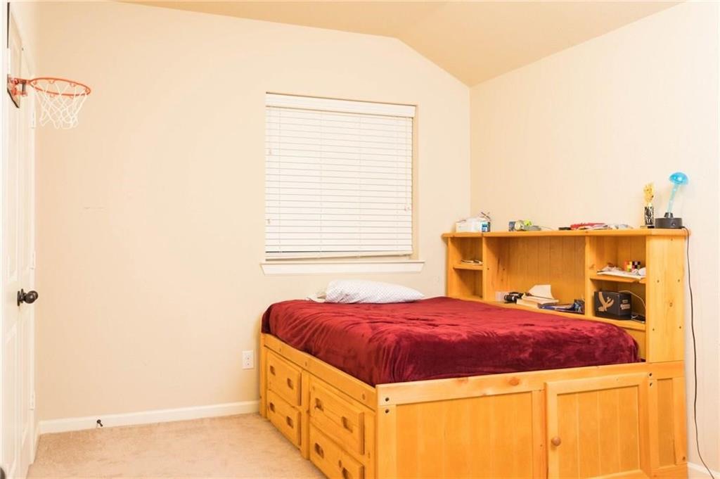 423 Palacio Street Irving, TX 75039 - Photo 9 of 18 Bedroom with vaulted ceiling and light carpet