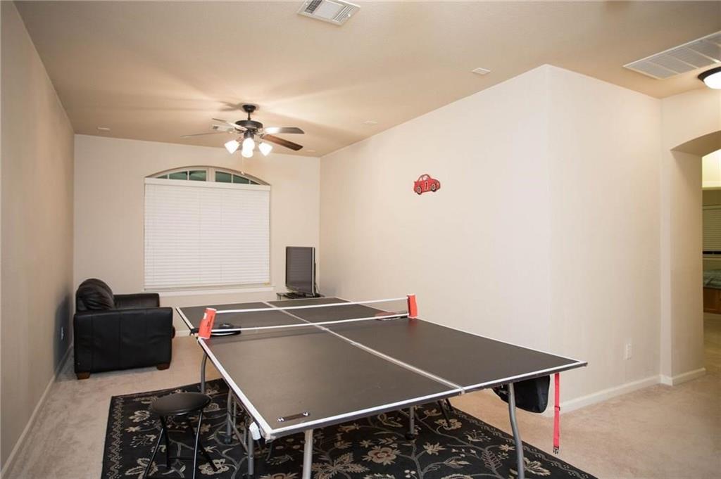 423 Palacio Street Irving, TX 75039 - Photo 10 of 18 Rec room featuring light colored carpet, arched walkways, and a ceiling fan