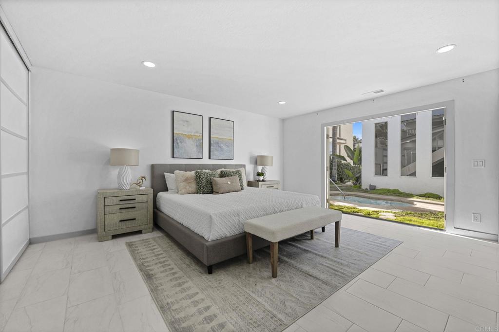 1561 Neptune Avenue Encinitas, CA 92024 - Photo 14 of 30 a spacious bedroom with a bed and a large window