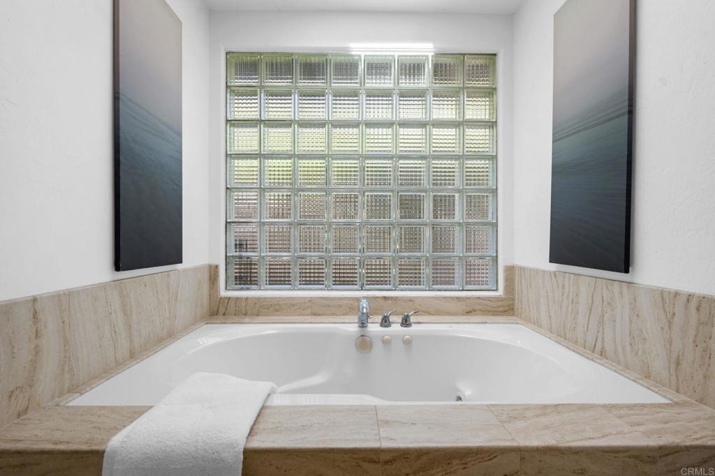1561 Neptune Avenue Encinitas, CA 92024 - Photo 16 of 30 a bathroom with a bathtub and window