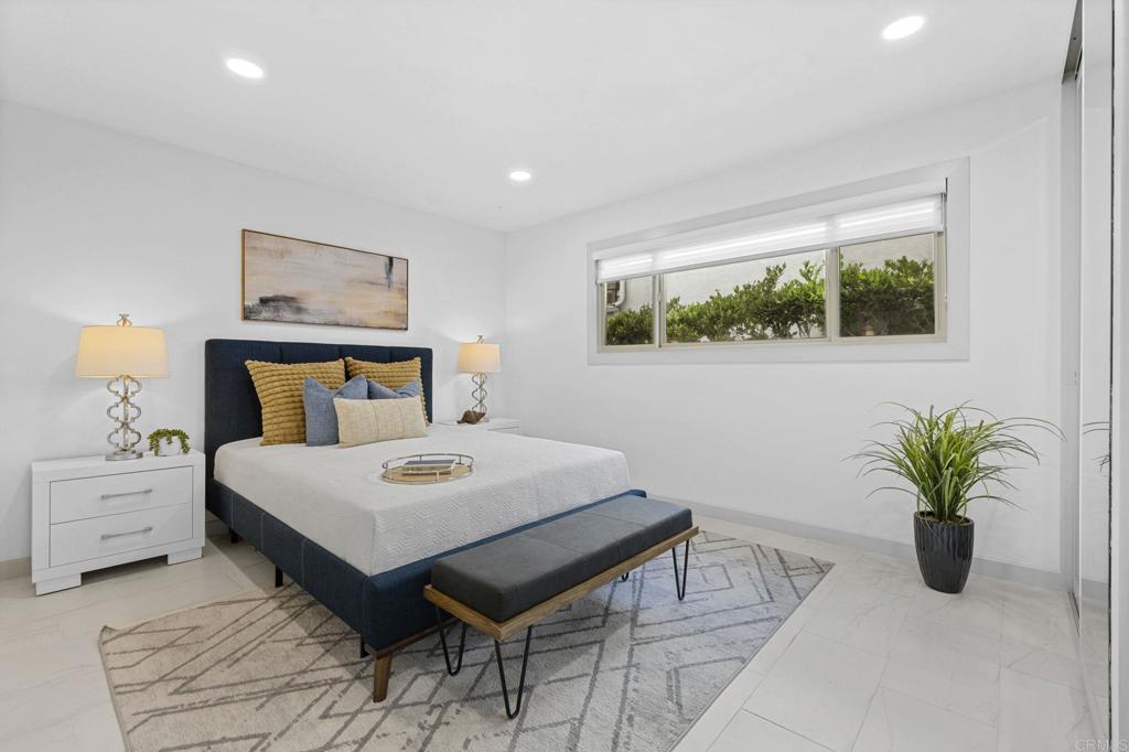 1561 Neptune Avenue Encinitas, CA 92024 - Photo 17 of 30 a bedroom with a bed and a potted plant