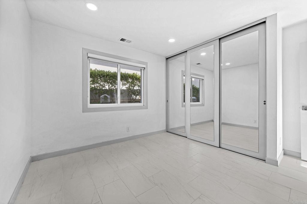 1561 Neptune Avenue Encinitas, CA 92024 - Photo 18 of 30 an empty room with windows and closet
